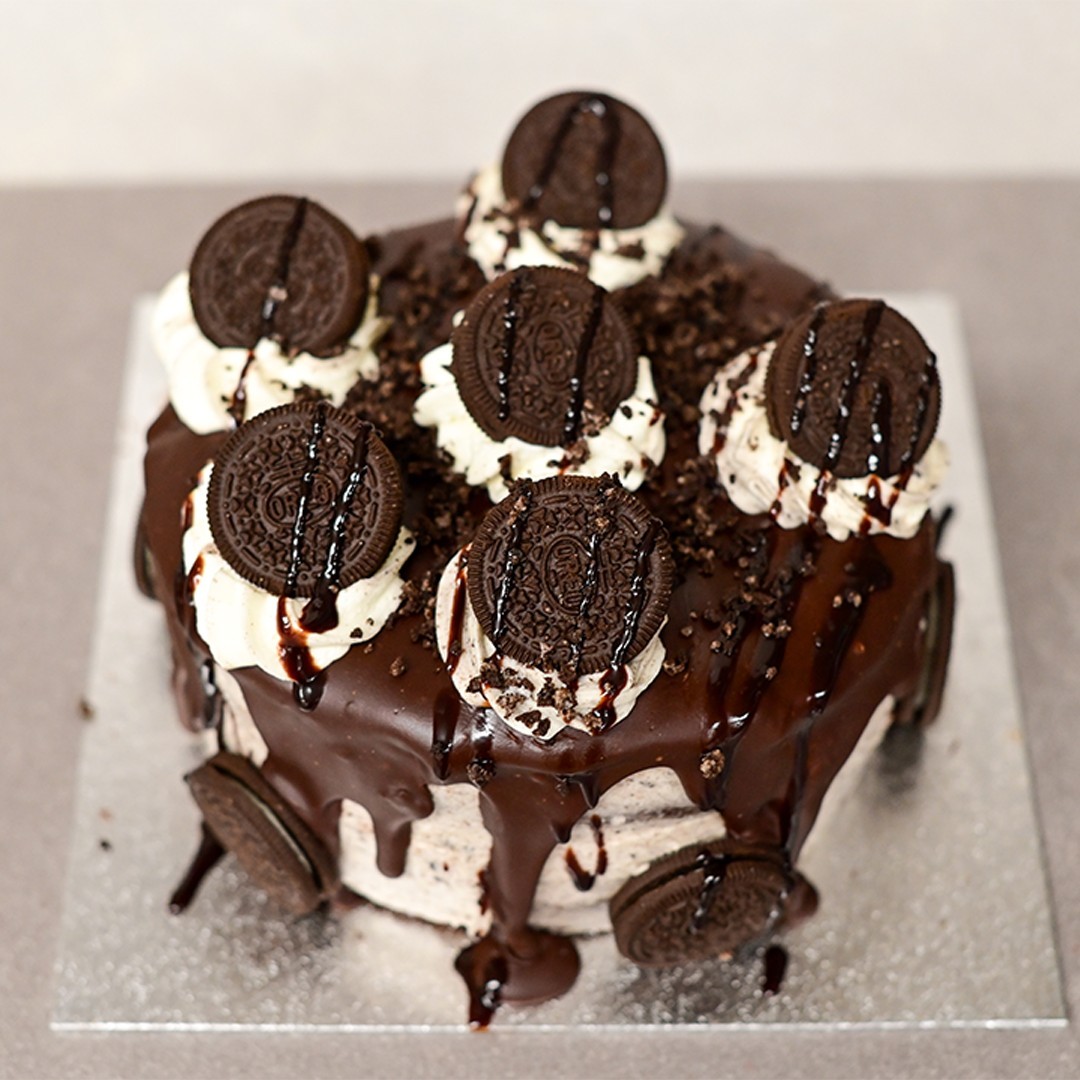 Chocolate drip cake topped with cream swirls, Oreo biscuits and chocolate sauce from Simpson's Street Bakery